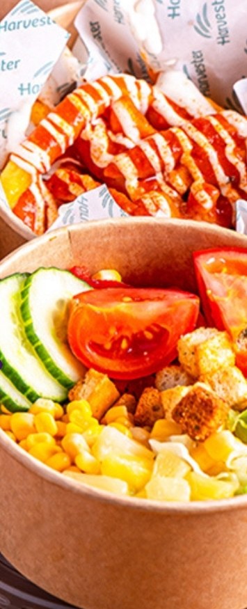 A takeaway bowl of chicken, sweetcorn, tomato and sauce